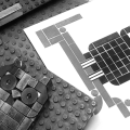 Black and white photo of Lego print blocks and print.