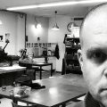 in grainy black and white with drawing cabinets, large wooden type and other tools. 