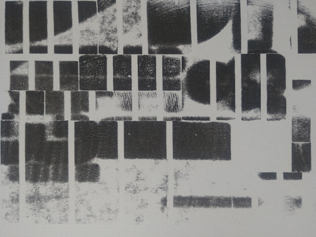 Detail of an abstract print in black and white of an irregular rectangular pattern.