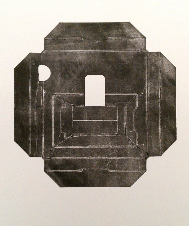 A square print of packaging with nested folding lines and 2 small cutouts