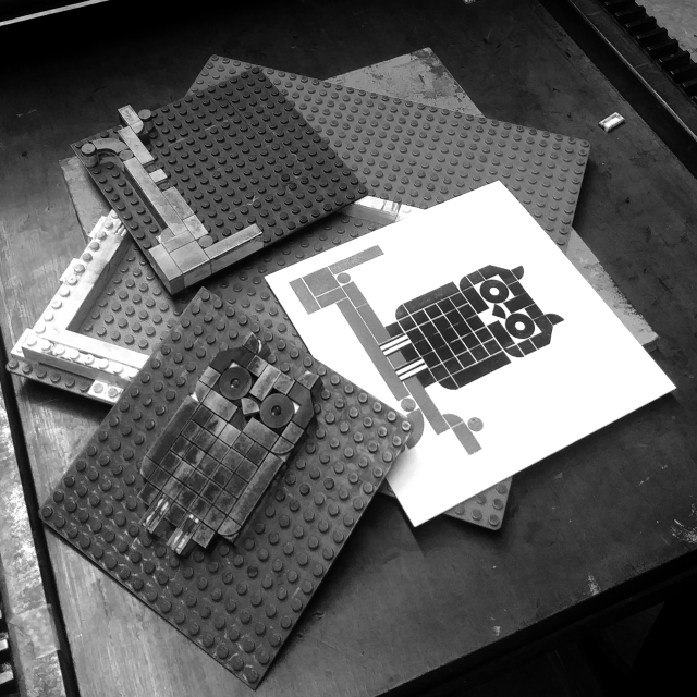 Black and white photo of Lego print blocks and print.