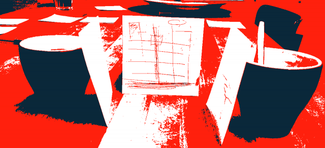 3 square pieces of paper leaning agains coffee cups to suggest an exhibition stand.